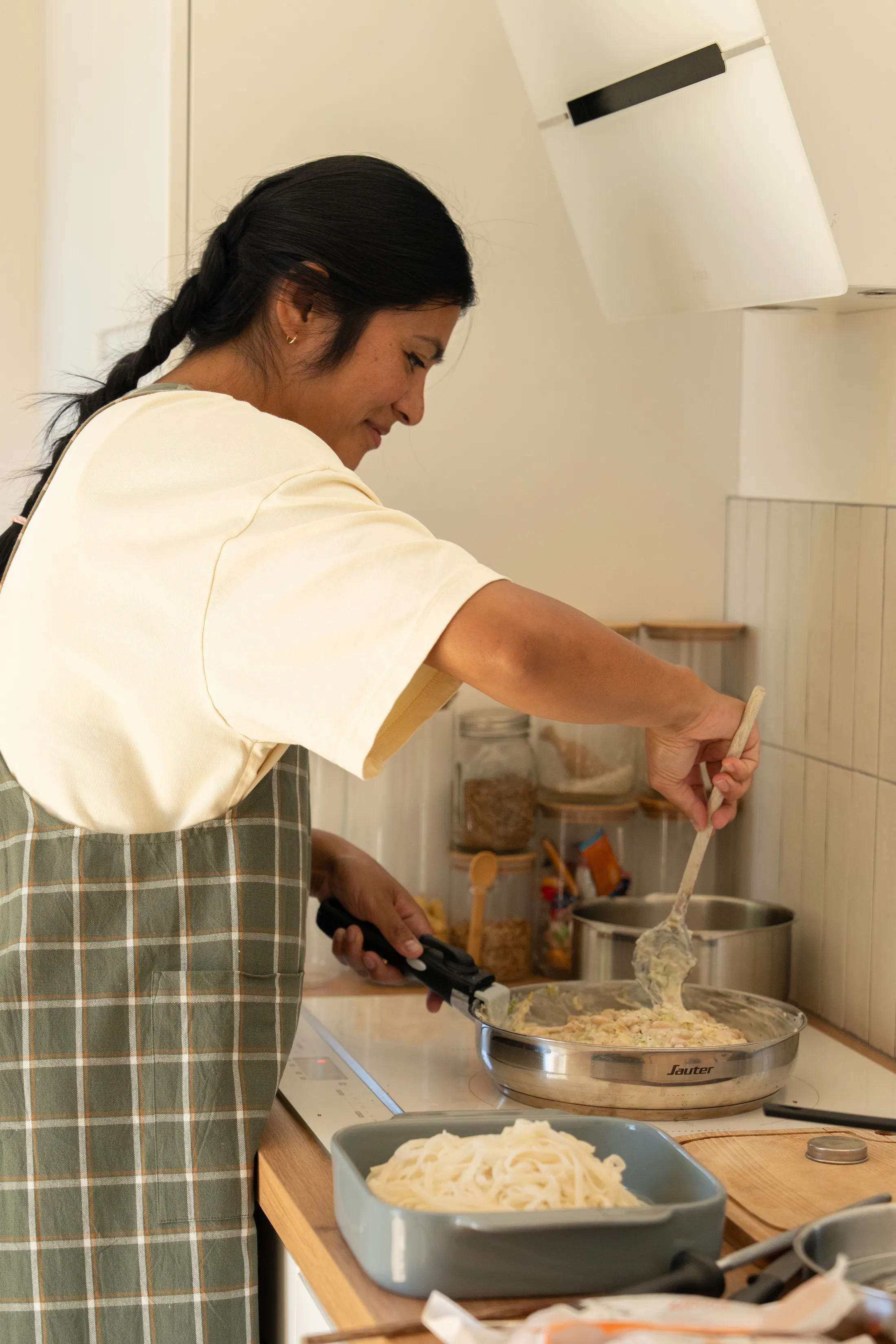 Christina en pleine préparation, de profil dans sa cuisine.